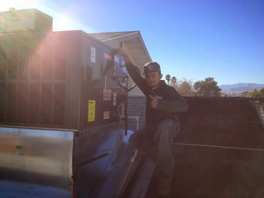 HVAC technician performing HVAC Inspection on a rooftop unit in Lititz